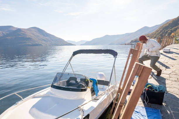 istock Young man cleaning and preparing boat for the winter 1360230374