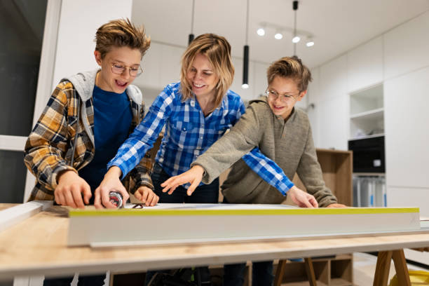 istock Mother and sons making kitchen installation at home 1360230399