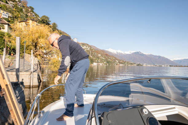 istock Senior man docking his boat at the pier 1360230645