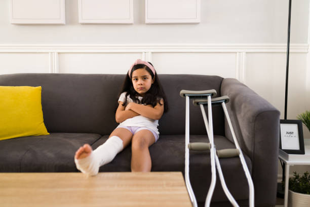 istock Sad little girl with a broken leg 1360231472