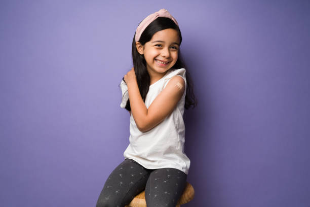 istock Cute kid with a band aid in her arm 1360231483