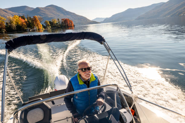 istock Mature man driving speedboat 1360231733