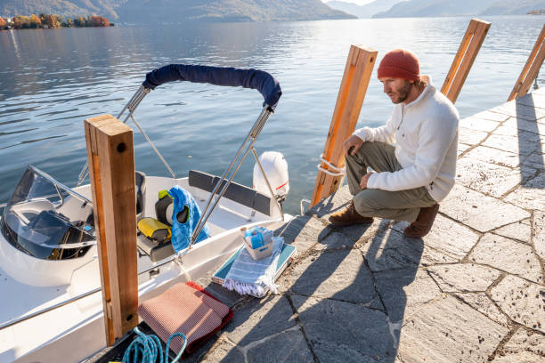 istock Young man cleaning and preparing boat for the winter 1360231934