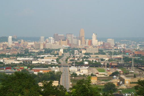 Cincinnati Ohio Cityscape from the west.  Hazy afternoon.  Industrial area in near ground.