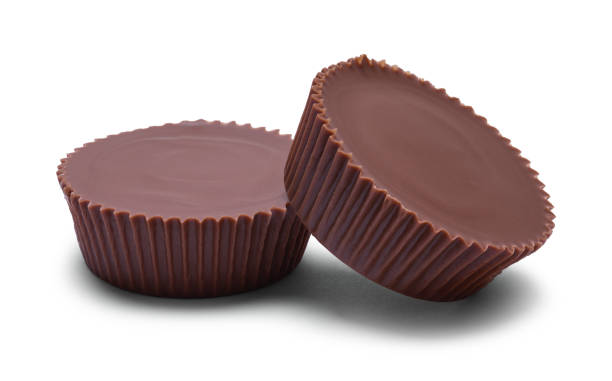 Peanut Butter Cups Two Chocolate Peanut Butter Cups Cut Out on White. peanut butter stock pictures, royalty-free photos & images