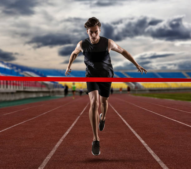 istock Sporty man running on the athletic track 1360235554
