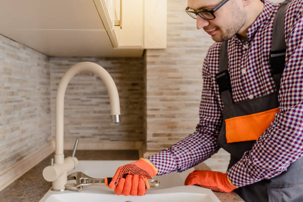 istock installer fixes with wrench the water tap pipe in vintage kitchen 1360235675