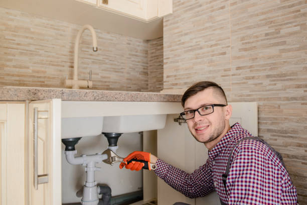 istock installer fixes with wrench the water tap pipe in vintage kitchen 1360236745