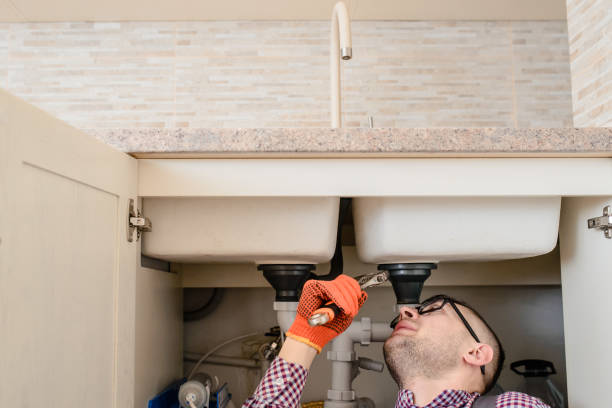 istock installer fixes with wrench the water tap pipe in vintage kitchen 1360236806