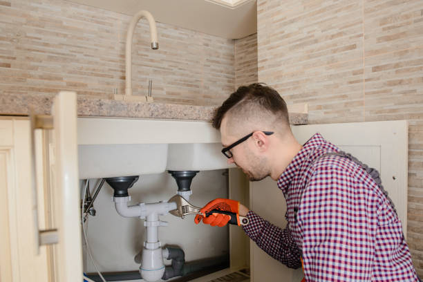 istock installer fixes with wrench the water tap pipe in vintage kitchen 1360236834