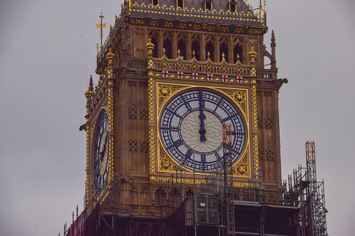 London, UK - December 21 2021: Scaffolding is removed from the top part of Big Ben to reveal all clock faces as the renovation of the iconic landmark nears completion.