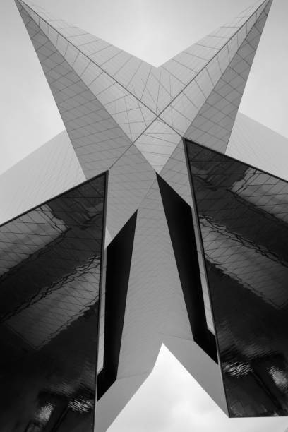 Digitally rendered modern architecture background with reflections. Abstract black and white building fragments with angular structure in dramatic light.