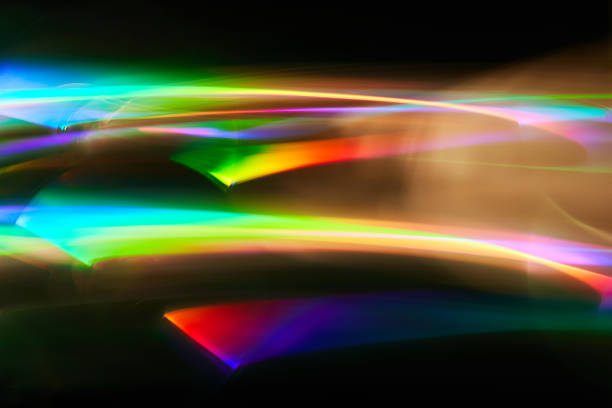 istock Blurred Light painting one exposure in camera. light glares with a spectral gradient on a dark background. Multicolored abstract colorful line. Unusual light effect. 1360239180