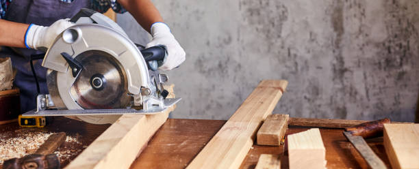 istock Skilled female carpenter using a circular saw. Woman worker in the carpenter workroom renovation. Small business concept 1360239238