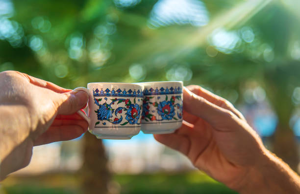 cups with turkish coffee in hands. selective focus. - türk kahvesi stok fotoğraflar ve resimler