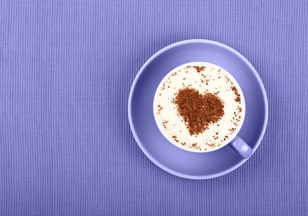 istock Close up latte cappuccino coffee cup on purple 1360243319