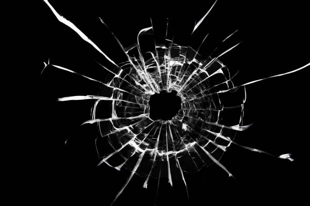 istock Texture of a broken shot window on a black background. 1360243394