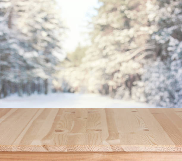 istock empty wooden table on a winter background, a mockup 1360248223