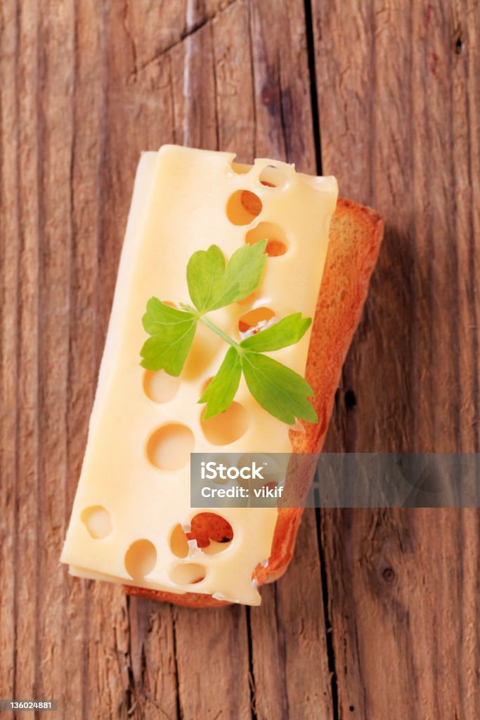 Cheese on toast Thin slice of Emmentaler cheese on toast Appetizer Stock Photo