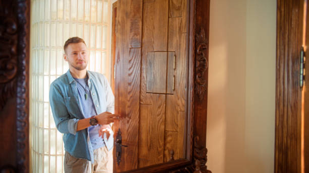 istock Man getting ready to leave home. Last touch ups in hall mirror 1360250101