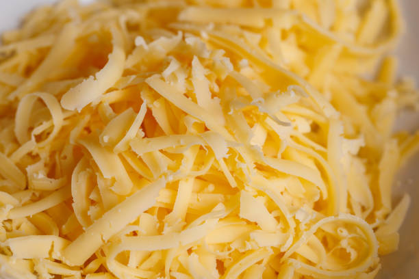 istock full frame close-up background of grated cheese with selective focus 1360250152