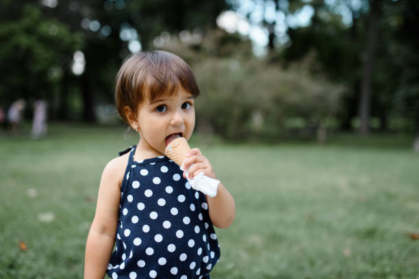 istock girl kid is eating an ice cream 1360250159