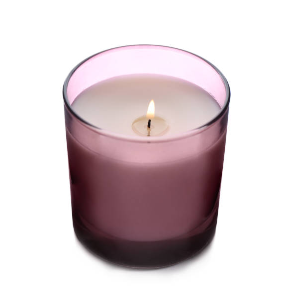 istock Burning wax candle in holder isolated on white 1360251667