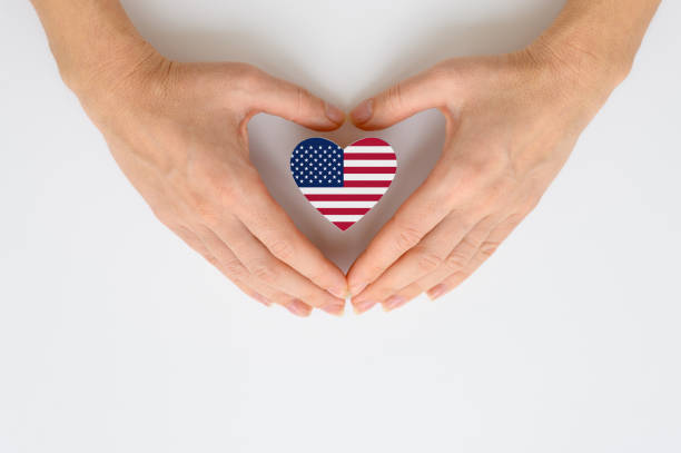 istock United States flag in female hands. 1360252559