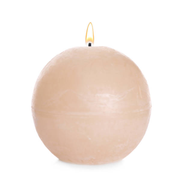 istock Burning beige wax candle isolated on white 1360252570