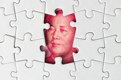 Mao Tse-tung under the missing puzzle pieces.