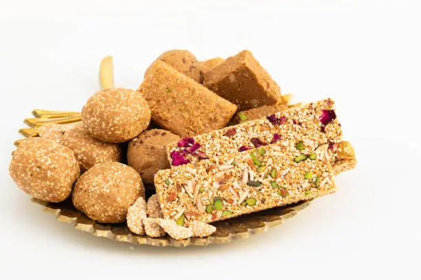 Photo of Winter Delicacy Makar Sankranti Or Lohri Mithai Gulab Gajak, Pista Gazak, Til Patti Or Papdi, Til Laddu Or Ladoo, Revdi And Rewri Is Made Of Tilgul, Mungfali, Sesame Seed, Jaggery Gud, Badam And Pista