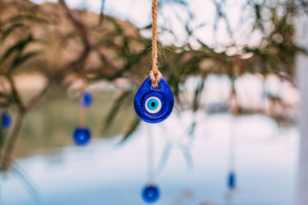 istock Evil Eye Beads Hanging From a Tree on the Beach 1360255386