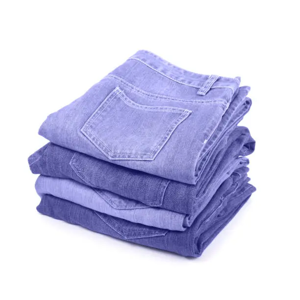 Photo of Stack of jeans in color of the 2022