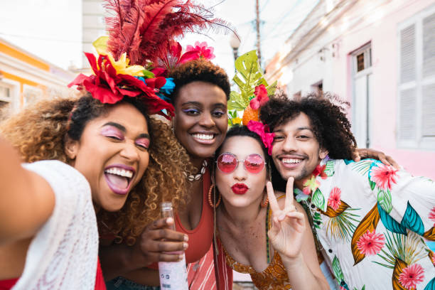 friends in costumes have fun at brazil carnival party in the street. - carnival imagens e fotografias de stock