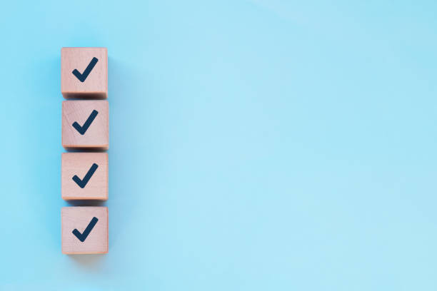 istock Checklist concept, Check marks on wooden cube blocks, blue background with free copy space 1360261062