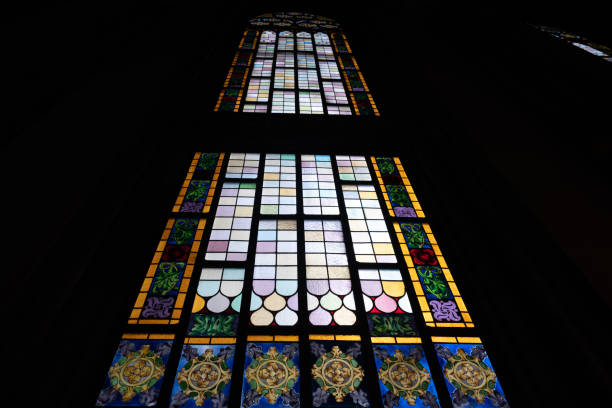 istock Coloured stained glass window in a church 1360261846