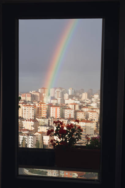 istock Rainbow seen from the window of a room 1360261847