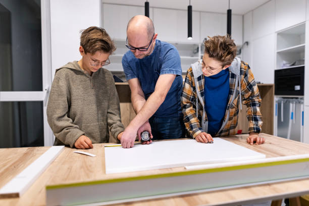 Father and sons making kitchen installation at home