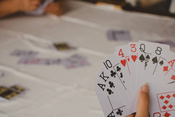 istock holding a fan of cards 1360264893