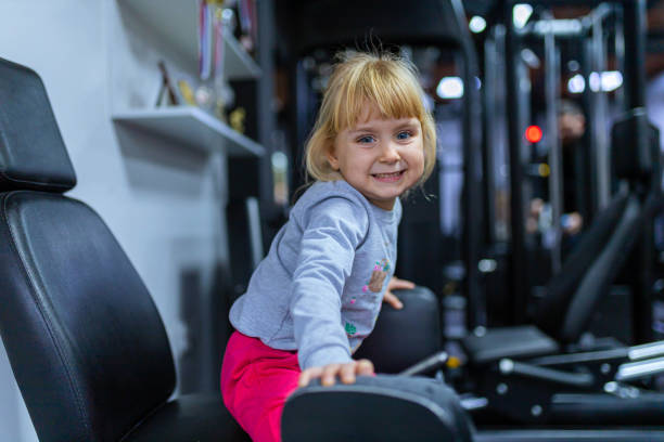 istock Curious and charming girl exploring the gym 1360265559