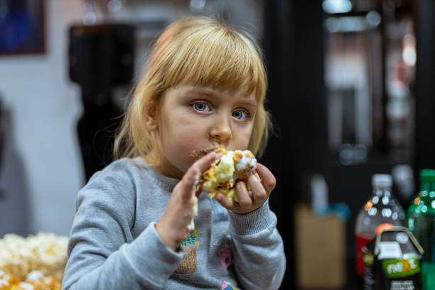 Hungry little girl eating a sandwich at the gym