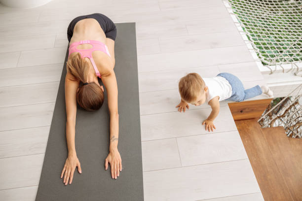 istock Woman doing yoga while stretching in the room 1360266808
