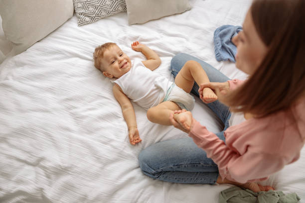 istock Young lady with her kid during changing the clothes 1360266880