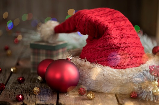 Santa Hat with Christmas Bokeh Lights on a Rustic Wood Background