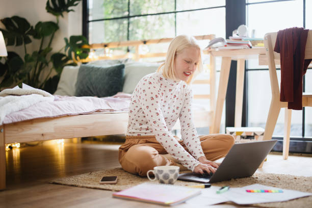 istock Young female student studying at home 1360271093