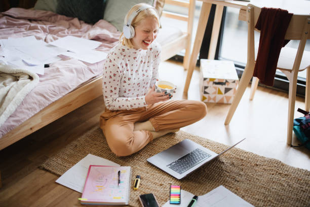 istock Positive woman video calling using laptop at home 1360271112