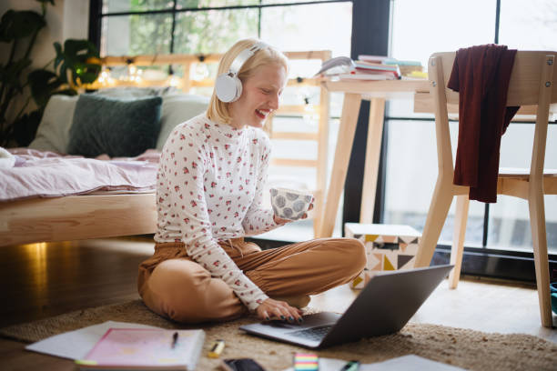 istock Positive woman video calling using laptop at home 1360271114
