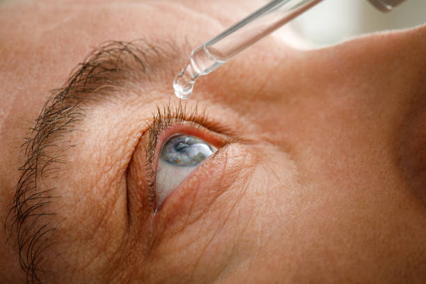 istock A man moistens his eyes before installing contact lenses. Drops in the eyes from irritation, redness and allergies 1360274833