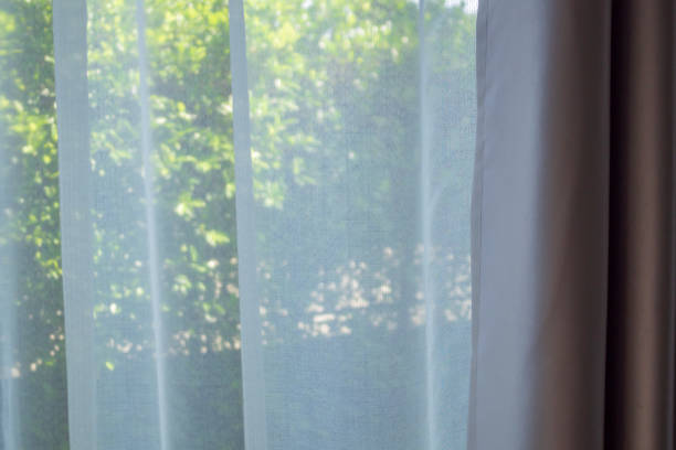 istock Close up curtain window with green garden background 1360274934