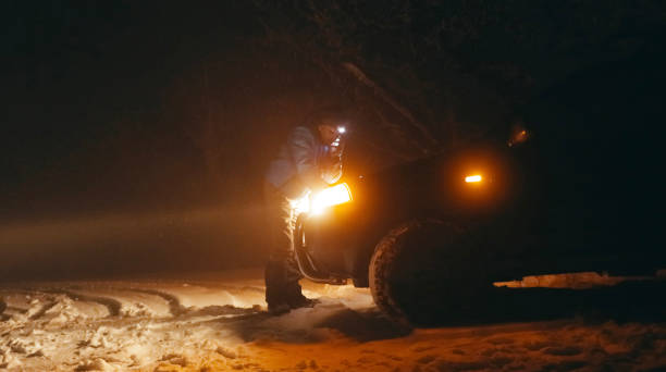 istock Man with car issues on winter road, phone calling for help. 1360275894